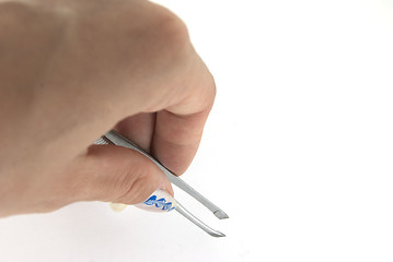 Image showing A woman hand with a tweezer