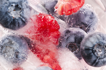 Image showing Raspberry and blackberry frozen in ice sticks