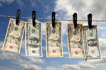 Image showing paper dollars are drying on rope