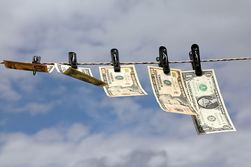 Image showing paper dollars are drying on rope