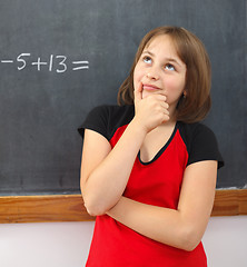 Image showing Elementary schoolgirl thinking on solution