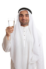 Image showing Happy arab man holding a glass of fresh drinking water