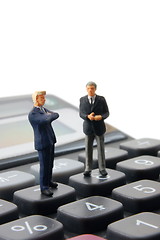 Image showing business people on calculator isolated