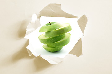 Image showing sliced apple and hole in paper