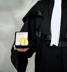 Image showing Lawyer wearing a robe holdong a a justice meda