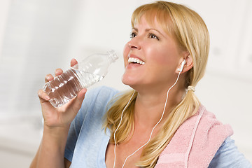 Image showing Pretty Blonde Woman with Towel Drinking From Water Bottle