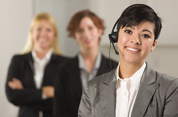 Image showing Pretty Hispanic Businesswoman with Colleagues Behind