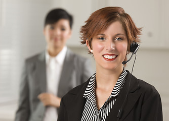 Image showing Pretty Red Haired Businesswoman with Headset in Office