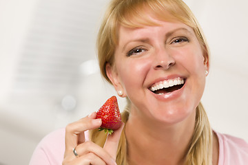 Image showing Pretty Smiling Blonde Woman Holding Strawberry