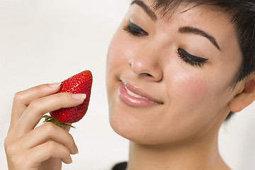 Image showing Pretty Hispanic Woman Holding Strawberry