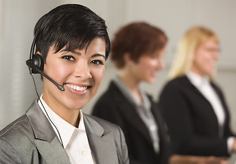 Image showing Pretty Hispanic Businesswoman with Colleagues Behind