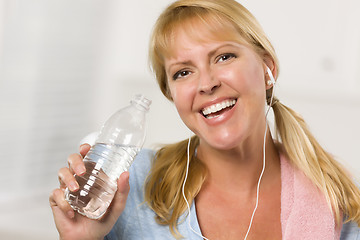 Image showing Pretty Blonde Woman with Towel Drinking From Water Bottle