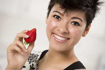 Image showing Pretty Hispanic Woman Holding Strawberry