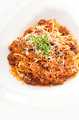 Image showing spaghetti with bolognese sauce and fresh vegetables on backgroun
