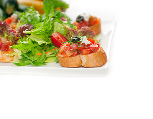 Image showing original Italian fresh bruschetta served with fresh salad and ve