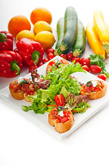 Image showing original Italian fresh bruschetta served with fresh salad and ve