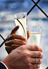 Image showing Two hands holding wedding champagne