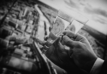 Image showing Two hands holding wedding champagne