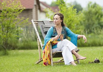 Image showing Young woman relaxing on nature