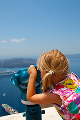 Image showing Girl looking with binoculars in Thira, Santorini, Greece