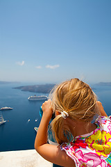 Image showing Girl looking with binoculars in Thira, Santorini, Greece