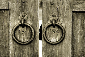 Image showing ancient wooden gate with door knocker rings
