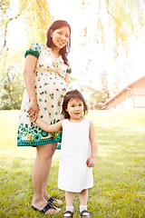 Image showing Pregnant Asian mother and her daughter