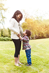 Image showing Pregnant Asian mother and her son