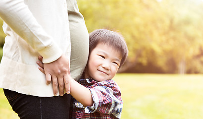 Image showing Pregnant Asian mother and her son