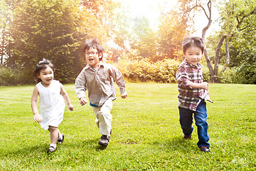 Image showing Asian kids running in park