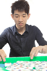 Image showing Chinese man play Mahjong, traditional China gamble. 