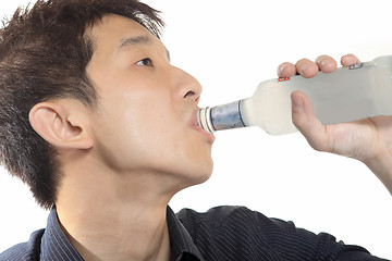 Image showing asia man takes drink