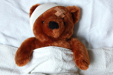 Image showing sick teddy with injury in bed