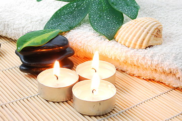 Image showing foldet white bath towel and zen stones