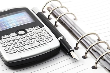 Image showing note book and phone