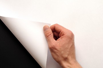 Image showing hand turning paper