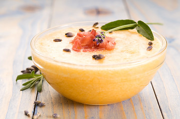 Image showing fresh melon soup with parma ham and lavender flower