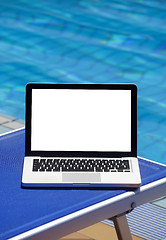 Image showing 	Laptop by swimming pool 