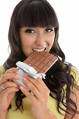 Image showing Beautiful girl eating decadent chocolate bar