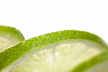 Image showing Slices of lime fruit on white