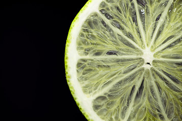 Image showing A single slice of lime on black