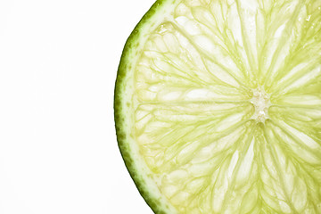 Image showing A single slice of lime on white