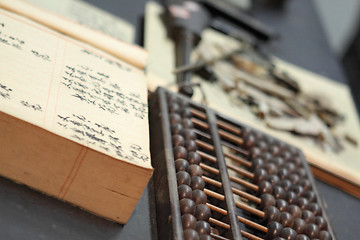 Image showing abacus and book on the table in a chinese old shop