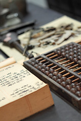 Image showing abacus and book on the table in a chinese old shop