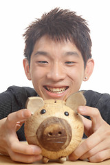 Image showing asia man with piggy bank 