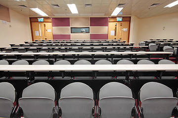 Image showing Empty hall for presentation with grey armchairs 