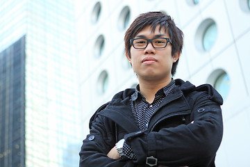 Image showing asian man stand in front of building