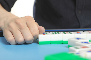 Image showing Chinese man play Mahjong, traditional China gamble. 