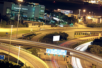 Image showing Freeway in night with cars light in modern city. 