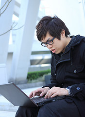 Image showing asian man using notebook